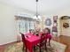 Dining room featuring hardwood floors, a large window, and a chandelier at 27023 Old English Ct, Leesburg, FL 34748
