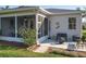 Home exterior showing a patio area with seating, fire pit and screened in lanai at 27023 Old English Ct, Leesburg, FL 34748