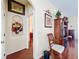 A hallway featuring hardwood floors and decorative wall art at 27023 Old English Ct, Leesburg, FL 34748