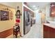 Well-lit kitchen with stainless steel appliances, dark wood cabinets, and tiled flooring at 27023 Old English Ct, Leesburg, FL 34748
