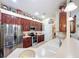 Functional kitchen showcasing stainless steel appliances, tile backsplash, and abundant cabinetry for storage at 27023 Old English Ct, Leesburg, FL 34748