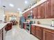 Bright kitchen with stainless steel appliances, dark cabinetry, and an open view into the adjacent dining area at 27023 Old English Ct, Leesburg, FL 34748