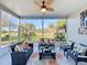 Enclosed Lanai offering comfortable seating and serene golf course views at 27023 Old English Ct, Leesburg, FL 34748