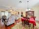 An expansive living room and dining room combination with hardwood floors and a ceiling fan at 27023 Old English Ct, Leesburg, FL 34748