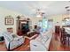 Spacious living room with hardwood floors, comfortable seating, and natural light from the sliding glass doors at 27023 Old English Ct, Leesburg, FL 34748