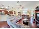 An expansive living room and dining room combination with hardwood floors and a ceiling fan at 27023 Old English Ct, Leesburg, FL 34748