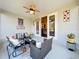Covered patio featuring stylish wicker furniture, an accent rug, and access to the home's interior at 27023 Old English Ct, Leesburg, FL 34748