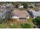 Aerial shot of home featuring a screened-in lanai and mature landscaping in a desirable neighborhood at 2712 Benavides Dr, The Villages, FL 32162