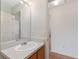 Bathroom with vanity, lights, mirror, and view into adjacent room at 2712 Benavides Dr, The Villages, FL 32162