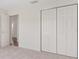 Bedroom featuring neutral carpet and large closet space at 2712 Benavides Dr, The Villages, FL 32162