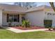 Close up of landscaped front yard with mulch, lighting, and fresh grass at 2712 Benavides Dr, The Villages, FL 32162