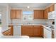 Kitchen with light countertops, wood cabinets, and a double sink at 2712 Benavides Dr, The Villages, FL 32162