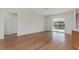 Light-filled living room with laminate flooring and a sliding glass door at 2712 Benavides Dr, The Villages, FL 32162