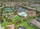 An aerial view of the community pool, tennis courts, clubhouse, and meticulously kept grounds at 3156 Vandenberg Ct, The Villages, FL 32163