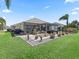 Expansive backyard with pergola-covered patio area and well-maintained landscaping at 3156 Vandenberg Ct, The Villages, FL 32163