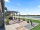 Outdoor patio area with pergola and beautiful lake views at 3156 Vandenberg Ct, The Villages, FL 32163