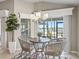 Charming breakfast nook featuring a modern chandelier and scenic views of the tranquil lake at 3156 Vandenberg Ct, The Villages, FL 32163