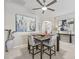 Cozy dining area featuring stylish seating, modern ceiling fan, and contemporary artwork creating a welcoming atmosphere at 3156 Vandenberg Ct, The Villages, FL 32163