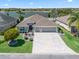 Beautiful single-Gathering home near a lake featuring pristine landscaping, an elegant driveway, and a three-car garage at 3156 Vandenberg Ct, The Villages, FL 32163