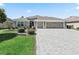 Lovely home with well manicured bushes, stone accents and a brick paved driveway at 3156 Vandenberg Ct, The Villages, FL 32163