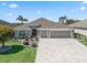 Charming single-Gathering home featuring pristine landscaping, an elegant driveway, and a three-car garage at 3156 Vandenberg Ct, The Villages, FL 32163