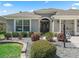 Close up of the front of the house with rock beds and a beautiful lawn at 3156 Vandenberg Ct, The Villages, FL 32163