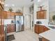 Functional kitchen space with stainless steel refrigerator, ample counter space, and dark wood cabinets at 3156 Vandenberg Ct, The Villages, FL 32163