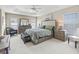 Serene main bedroom with tray ceiling, neutral tones, and large windows creating a peaceful retreat at 3156 Vandenberg Ct, The Villages, FL 32163