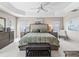 Spacious main bedroom featuring tray ceilings, ensuite bathroom, and neutral wall color at 3156 Vandenberg Ct, The Villages, FL 32163