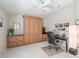 Home office with built-in cabinetry, Murphy bed, and desk providing a versatile workspace at 3156 Vandenberg Ct, The Villages, FL 32163