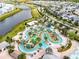 Aerial view of lazy river, waterslide, mini golf, community tennis court, lake, and residential area at 3180 Paradox Circle # 106, Kissimmee, FL 34746