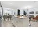 Open concept kitchen and dining area with a large island, modern lighting, and stylish décor at 3180 Paradox Circle # 106, Kissimmee, FL 34746