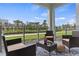 Relaxing outdoor patio with stylish seating, a woven rug, and peaceful views of the community at 3180 Paradox Circle # 106, Kissimmee, FL 34746