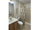 Well-lit bathroom featuring a vanity with sink, toilet, and bathtub with coordinating botanical-themed decor at 3183 Hatch Ln, The Villages, FL 32162