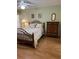 Cozy bedroom featuring a wooden bed frame, floral bedding, and a matching dresser at 3183 Hatch Ln, The Villages, FL 32162