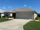 Charming single-story home with a covered front porch and an attached two-car garage at 3183 Hatch Ln, The Villages, FL 32162