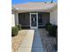 Inviting tiled front porch with walkway and decorative screen door at 3183 Hatch Ln, The Villages, FL 32162