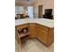 Corner kitchen island with bar stool seating and open cabinets at 3183 Hatch Ln, The Villages, FL 32162