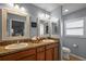 Functional bathroom with double sinks, framed mirrors, and a neutral color palette at 3186 Killington Loop, The Villages, FL 32163