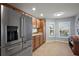 Bright eat-in kitchen featuring stainless steel refrigerator and backyard views at 3186 Killington Loop, The Villages, FL 32163