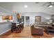 Inviting living room and dining area featuring wood floors, and neutral color palette at 3186 Killington Loop, The Villages, FL 32163