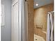 Modern tiled shower with grab bar, bench, and curtain at 3186 Killington Loop, The Villages, FL 32163