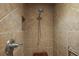 Tiled shower featuring a rainfall shower head and a convenient grab bar at 3186 Killington Loop, The Villages, FL 32163