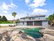 Home's backyard with a pool, screened-in porch, and patio furniture at 3234 Cypress Grove Dr, Eustis, FL 32736