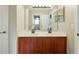 Bathroom featuring a double vanity with warm toned wood cabinets and large mirror at 3234 Cypress Grove Dr, Eustis, FL 32736