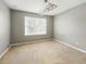 This bedroom features neutral walls, carpet and a modern light fixture at 3234 Cypress Grove Dr, Eustis, FL 32736