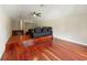 Spacious bonus room features hardwood floors, a ceiling fan, and is ready for customization at 3234 Cypress Grove Dr, Eustis, FL 32736