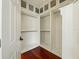 Spacious walk-in closet with custom shelving and hardwood floors at 3234 Cypress Grove Dr, Eustis, FL 32736
