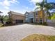 Charming two-story home with a stone facade, spacious driveway and lush landscaping at 3234 Cypress Grove Dr, Eustis, FL 32736