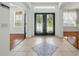 Bright foyer with decorative tile, front door with glass panes, and entry to adjacent rooms at 3234 Cypress Grove Dr, Eustis, FL 32736